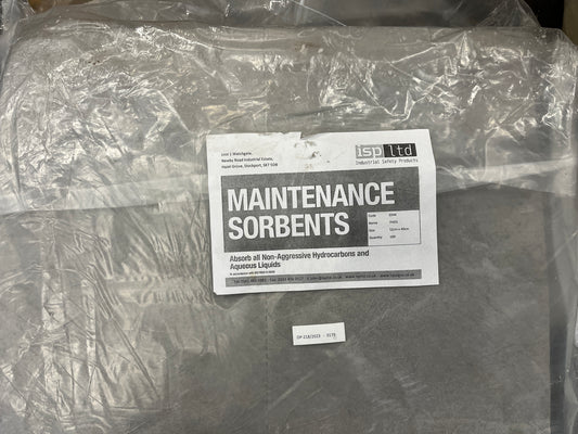 Packaged maintenance sorbents with a label on a concrete surface