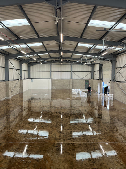 Warehouse concrete floor fully prepared by diamond grinding and sealed with epoxy primer, ready for resin floor coating.