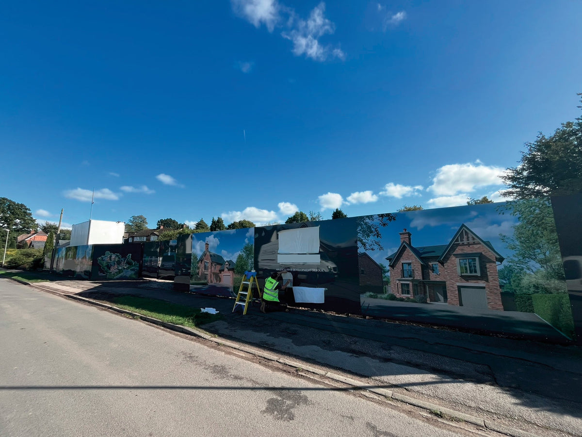 Printed hoarding panels around a development