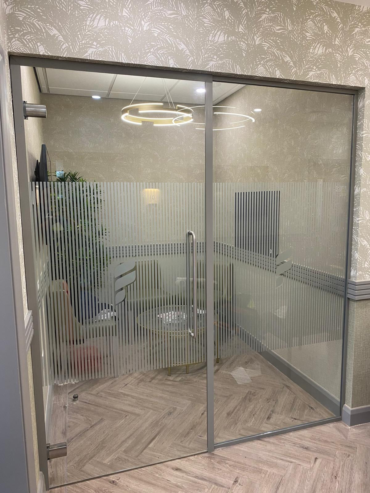 Etched frosted vinyl window glass office partition with cut-out company name and stripes