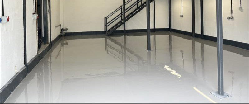 Empty warehouse with mezzanine, Self-Levelling Epoxy Resin Floor Coating and staircase