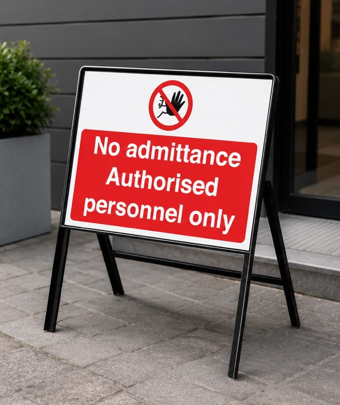 No Admittance Authorised Personnel Only stanchion sign positioned outside a commercial building entrance to restrict access.