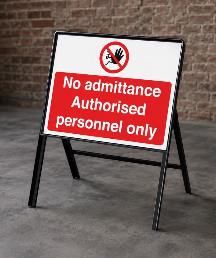 No Admittance Authorised Personnel Only stanchion sign displayed in an industrial workplace setting with brick wall background.