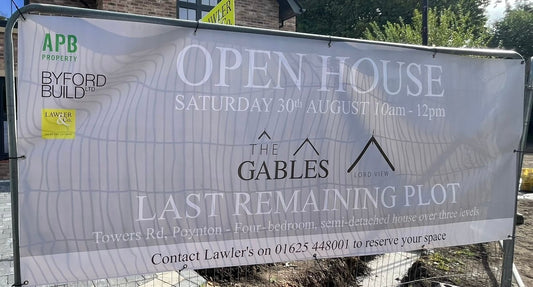 Open house banner for 'The Gables' with contact information on a construction site.
