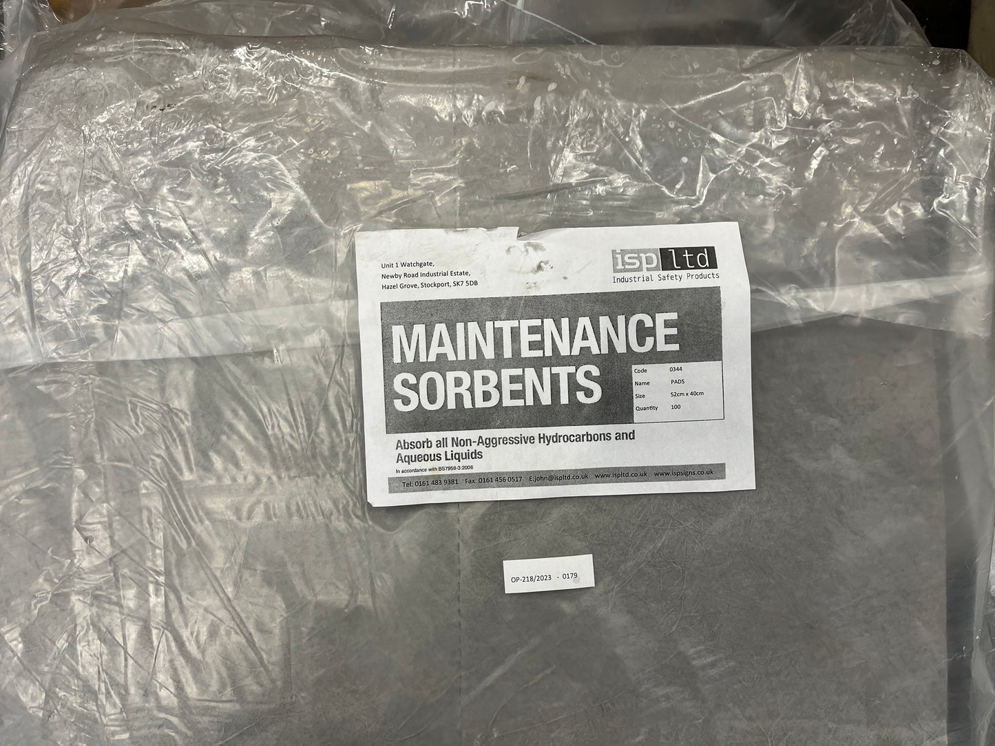 Packaged maintenance sorbents with a label on a concrete surface