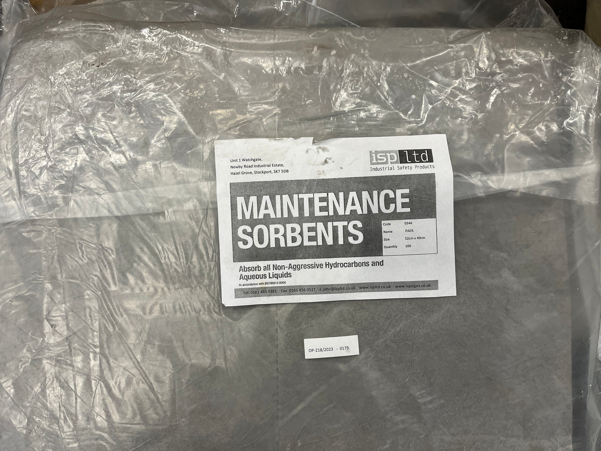 Packaged maintenance sorbents with a label on a concrete surface