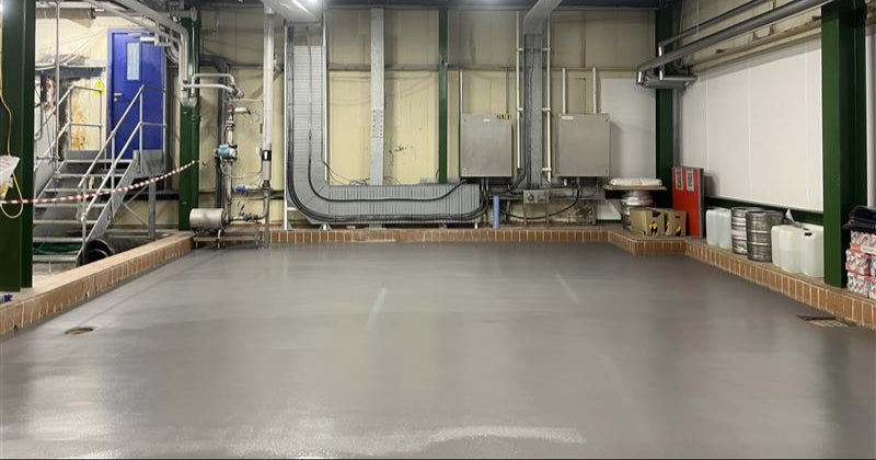 Industrial interior with Polyurethane Resin Flooring (PU Screed), metal beams, and various equipment.