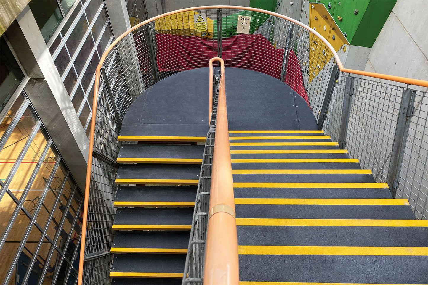 Staircase with yellow stripes in an indoor setting